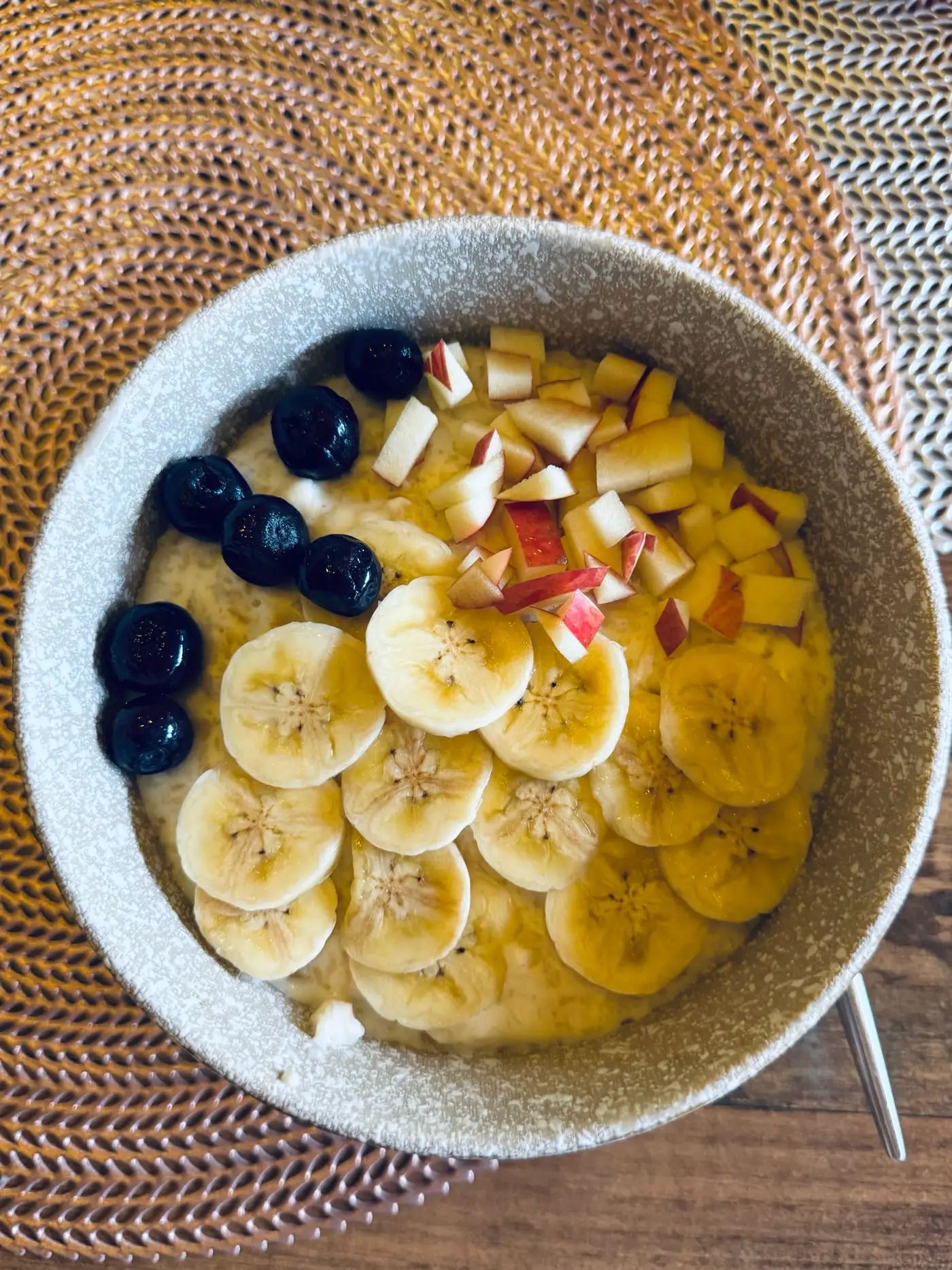 Bol de petit-déjeuner avec banane, myrtilles et fruits coupés